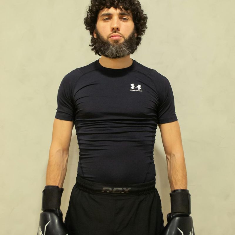 A focused man preparing for a strength exercise in a spacious loft.